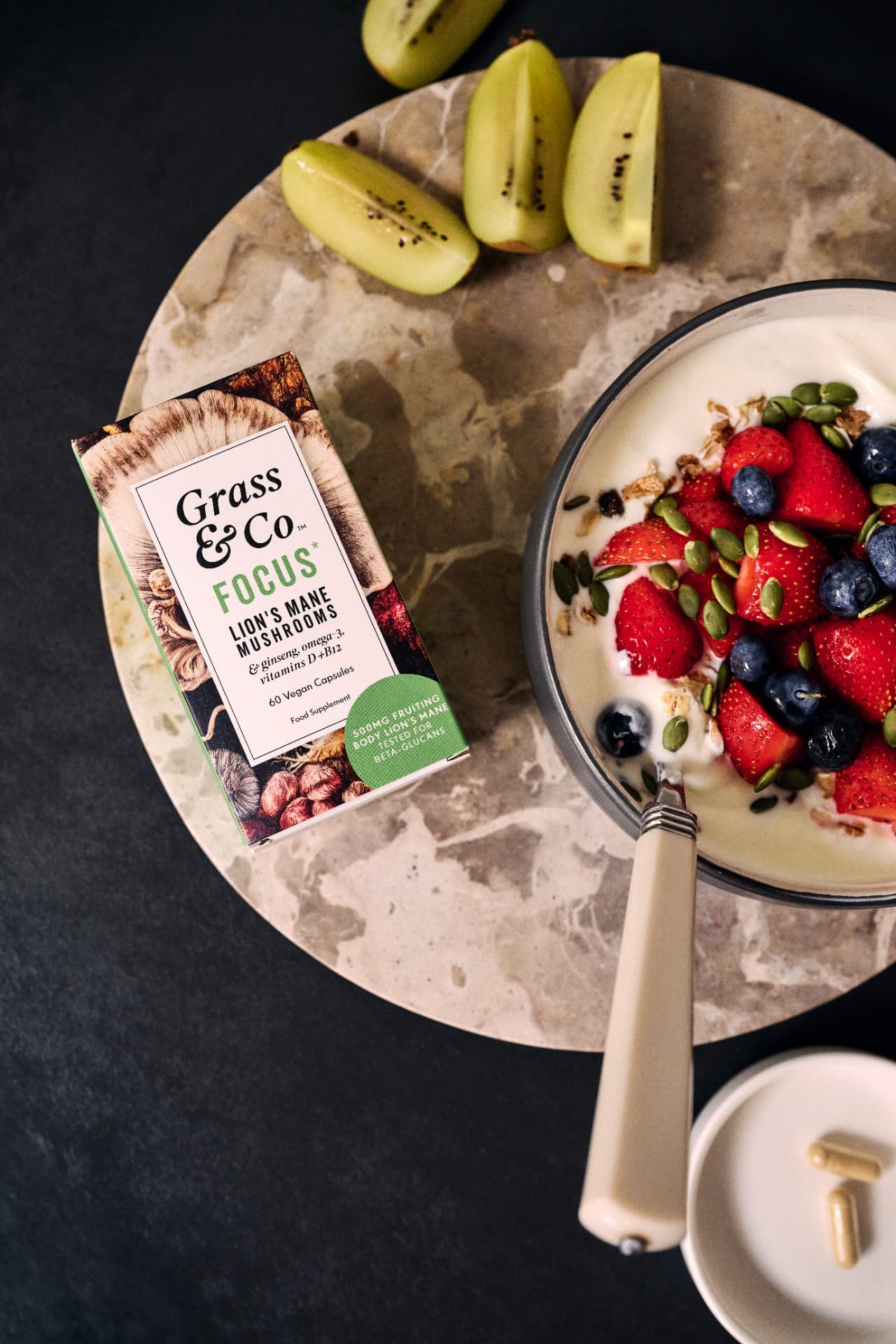 Overhead: FOCUS box beside a yogurt bowl, kiwi and granola